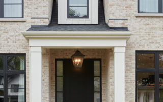 Luxury custom home in Oakville by Prasada Custom Homes with cream brick and black-framed windows